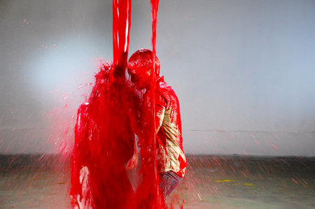 Red paint splashing on the floor of a building in the city
