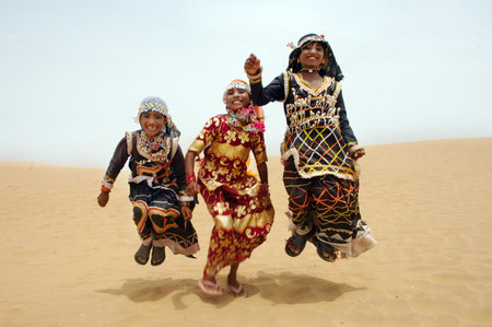 Unidentified Burmese women in traditional dress in the desert in Dubai, United Arab Emirates.のeditorial素材