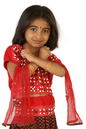 An adorable young Indian girl in a red sari.  On a white background.のeditorial素材