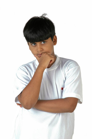 Portrait of a young boy thinking isolated on a white background.