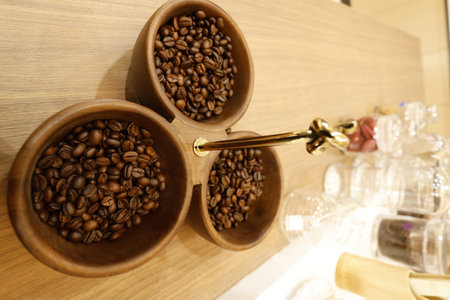 Coffee beans in a cup on a wooden table background.の写真素材