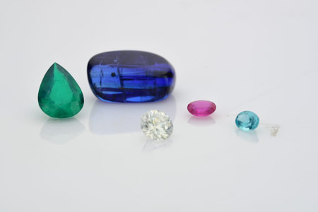 Blue and green sapphire gemstones isolated on white background.