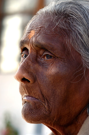 Portrait of an old Indian woman with grey hair and brown eyes