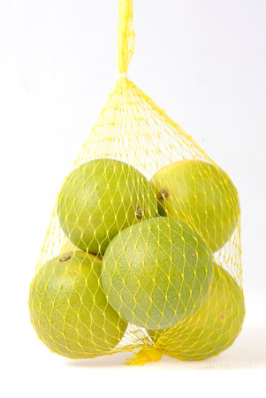 Lime in a string bag isolated on white background, Thailand.