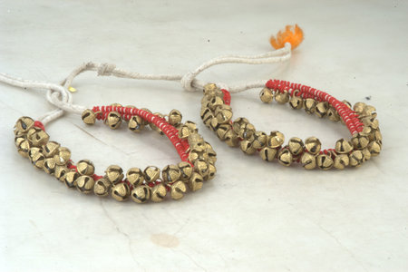 Beads with red thread on a white background.