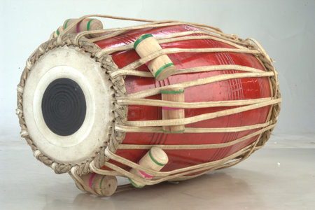 Close up of a red djembe drum on a white background