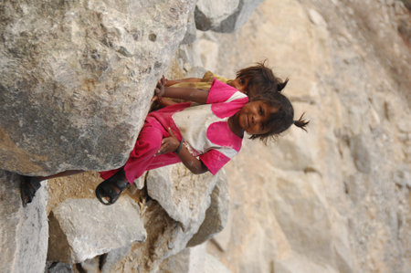 little girl climbing on a rock in the desert of Egypt, Africaのeditorial素材