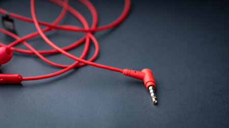 Red earphones on black background with copy space for your text.