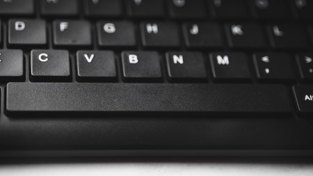 Close up of a black laptop keyboard with shallow depth of field.