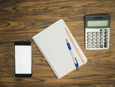 Notebook with pen and pencil on top tableの写真素材