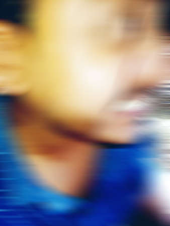An Indian or asian guy showing his funny facial expression to the camera. Blurred or defocused image.の写真素材
