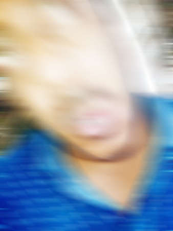 An Indian or asian guy showing his funny facial expression to the camera. Blurred or defocused image.の写真素材