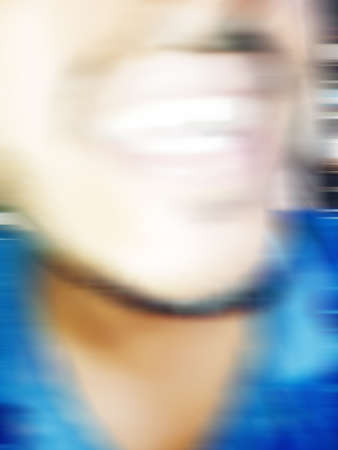 An Indian or asian guy showing his funny facial expression to the camera. Blurred or defocused image.の写真素材