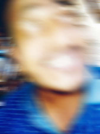 An Indian or asian guy showing his funny facial expression to the camera. Blurred or defocused image.の写真素材