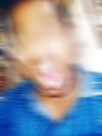 An Indian or asian guy showing his funny facial expression to the camera. Blurred or defocused image.の写真素材