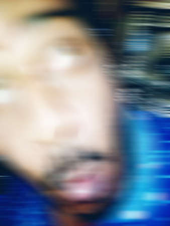 An Indian or asian guy showing his funny facial expression to the camera. Blurred or defocused image.の写真素材