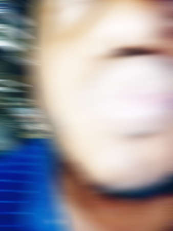 An Indian or asian guy showing his funny facial expression to the camera. Blurred or defocused image.の写真素材