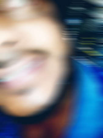 An Indian or asian guy showing his funny facial expression to the camera. Blurred or defocused image.の写真素材