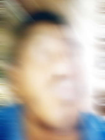 An Indian or asian guy showing his funny facial expression to the camera. Blurred or defocused image.の写真素材