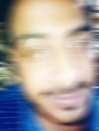 An Indian or asian guy showing his funny facial expression to the camera. Blurred or defocused image.の写真素材