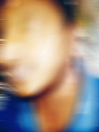 An Indian or asian guy showing his funny facial expression to the camera. Blurred or defocused image.の写真素材
