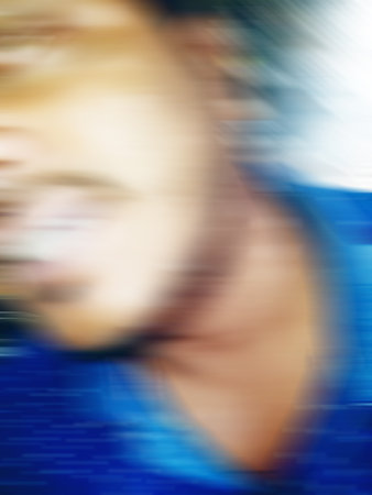 An Indian or asian guy showing his funny facial expression to the camera. Blurred or defocused image.の写真素材