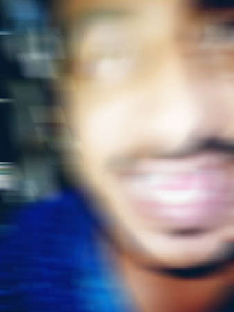 An Indian or asian man showing his funny facial expression to the camera. Defocused or blurred...