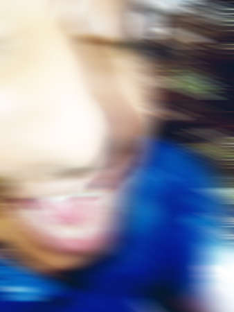 An Indian or asian guy showing his funny facial expression to the camera. Blurred or defocused image.の写真素材
