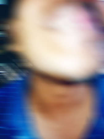 An Indian or asian guy showing his funny facial expression to the camera. Blurred or defocused image.の写真素材