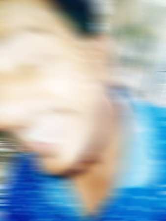 An Indian or asian guy showing his funny facial expression to the camera. Blurred or defocused image.の写真素材