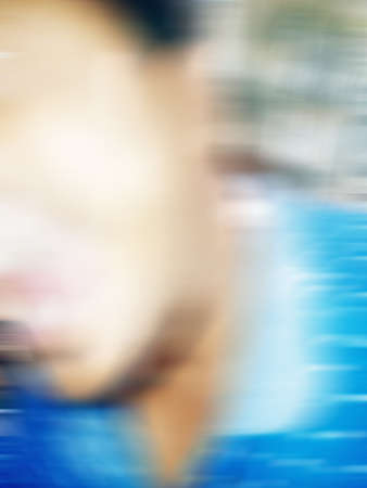 An Indian or asian guy showing his funny facial expression to the camera. Blurred or defocused image.の写真素材