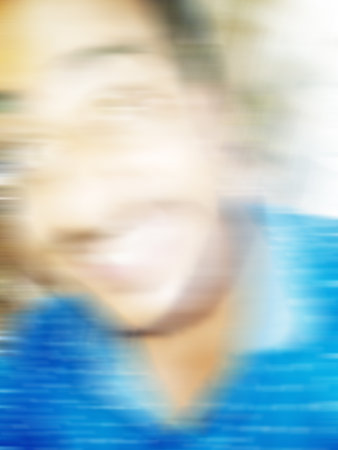 An Indian or asian guy showing his funny facial expression to the camera. Blurred or defocused image.の写真素材