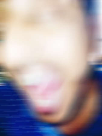 An Indian or asian guy showing his funny facial expression to the camera. Blurred or defocused...