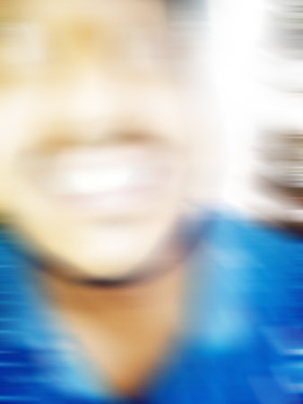 An Indian or asian guy showing his funny facial expression to the camera. Blurred or defocused image.の写真素材