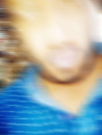 An Indian or asian guy showing his funny facial expression to the camera. Blurred or defocused image.の写真素材