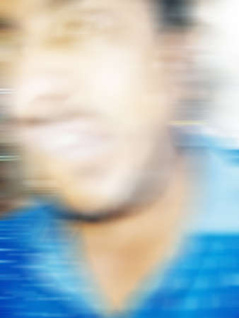 An Indian or asian guy showing his funny facial expression to the camera. Blurred or defocused image.の写真素材