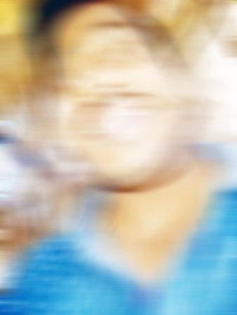 An Indian or asian guy showing his funny facial expression to the camera. Blurred or defocused image.の写真素材