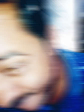 An Indian or asian guy showing his funny facial expression to the camera. Blurred or defocused image.の写真素材