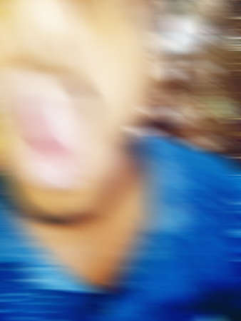 An Indian or asian guy showing his funny facial expression to the camera. Blurred or defocused image.の写真素材