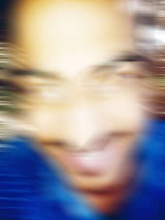 An Indian or asian guy showing his funny facial expression to the camera. Blurred or defocused image.の写真素材