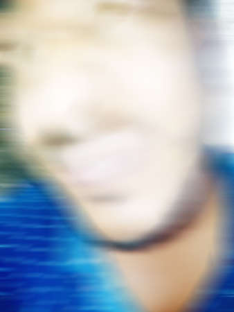 An Indian or asian guy showing his funny facial expression to the camera. Blurred or defocused image.の写真素材