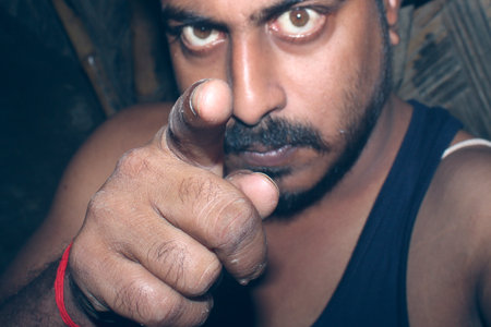 An Indian or asian man making noise in the house. Copy space.の写真素材