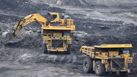 Ajmer, India - July 1, 2020 : Huge Dumper Earth mover Truck carrying minerals at an open pit quarry...