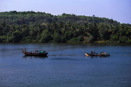 Fishermen on fishing boat fishing in the riverの写真素材