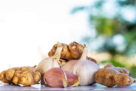 closeup of fresh organic garlic and ginger roots.