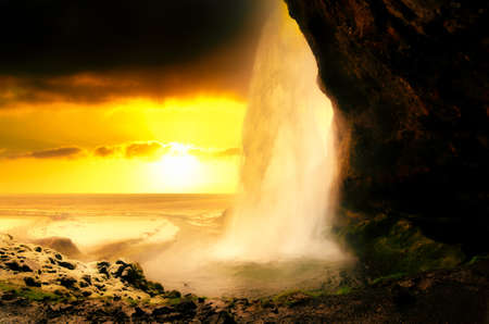 Seljalandsfoss Waterfall on the South Coast of Iceland bathed in the otherworldly light of the...