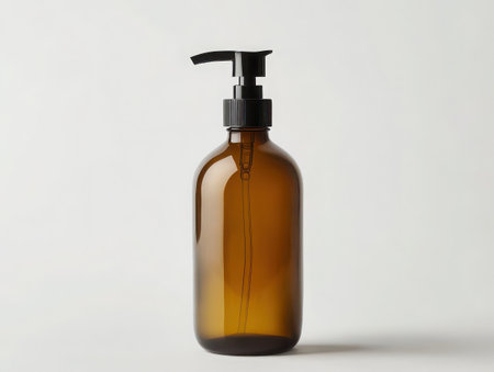 Amber glass bottle, black pump dispenser, minimalist design, apothecary style, transparent glass, liquid soap container, bathroom accessory, clean aesthetic, refillable bottle, eco-friendly packaging, warm tones, studio lighting, white background, product photography, sleek silhouette, modern cosmetic packaging, high-resolution image, crisp details, elegant simplicity -の素材