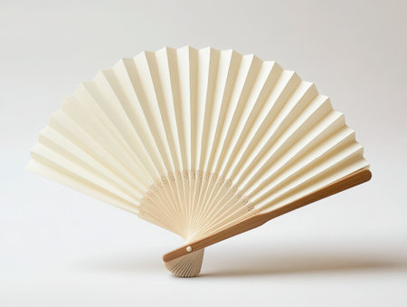 Elegant folding fan, cream-colored paper, wooden ribs, traditional Asian design, pleated texture, intricate craftsmanship, minimalist aesthetic, soft beige tones, cultural accessory, open fan shape, delicate wooden handle, symmetrical pattern, lightweight appearance, artistic object, studio lighting, clean background, vintage charm, ceremonial item, detailed fan construction, gentle curves -の素材