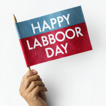 A hand holds a small flag with 'Happy Labor Day' text. The flag is divided into blue and red sections, creating a patriotic and festive feel for the labor celebration.の素材