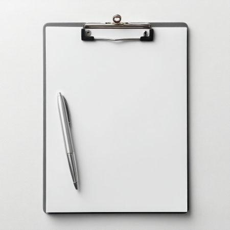 A top-down view of a clipboard holding a blank paper sheet, accompanied by a silver pen. The setup is clean and simple, ideal for showcasing layouts or designs on the paper surface.の素材